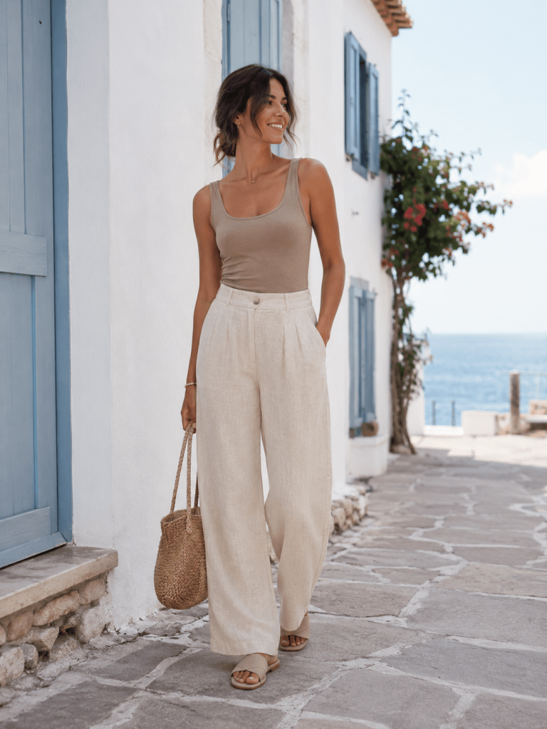 Cute Outfit Ideas for Women, linen pants, fitted tank top, slide sandals, and woven bag, warm summer outfit idea